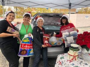 Philoptochos Long Beach volunteers loading food donations for families in need